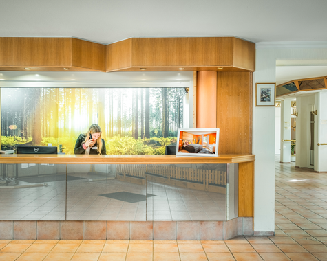 Empfangsbereich mit Holzverkleidung und großer Fensterfront