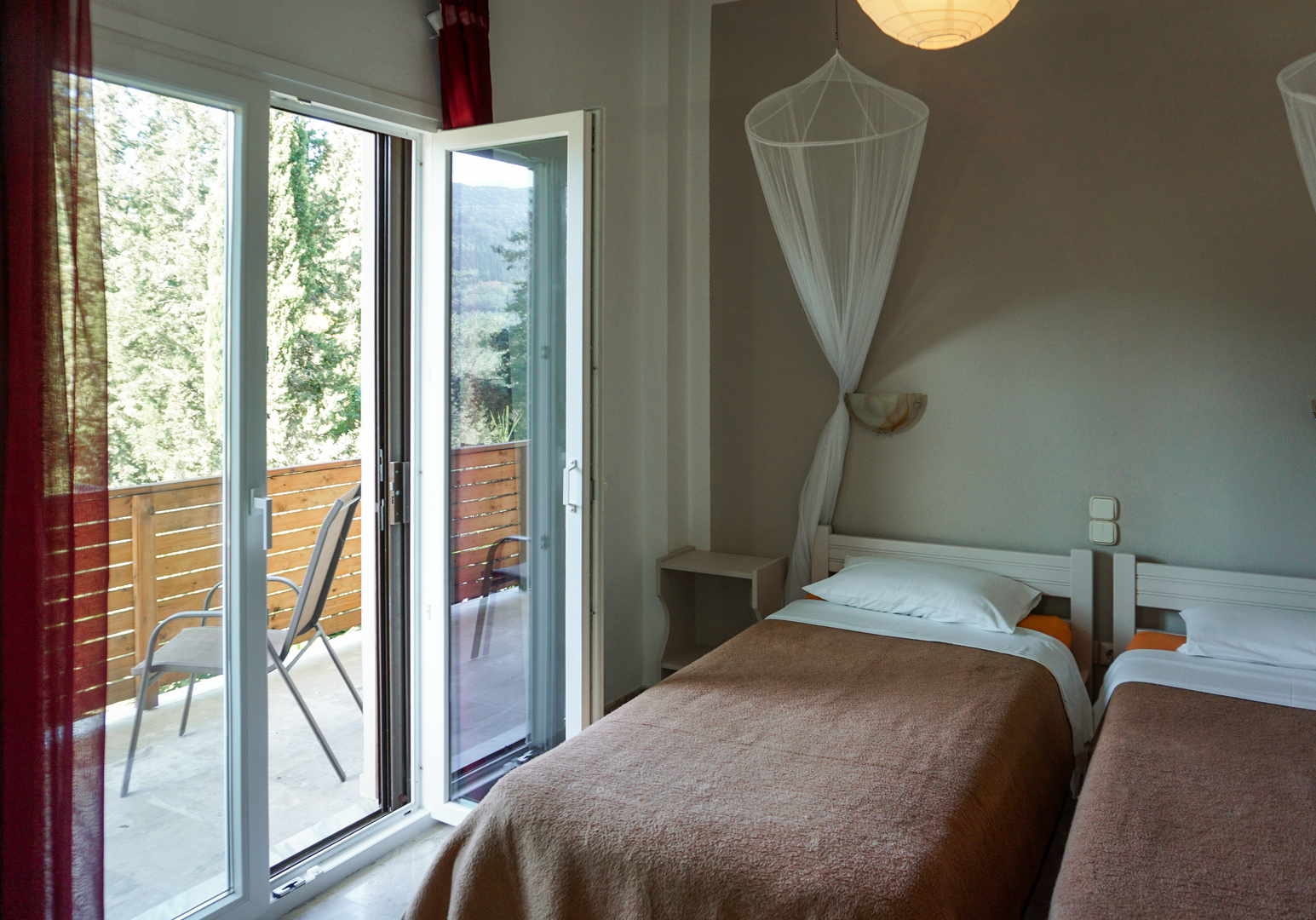 Schlafzimmer mit Einzelbetten und Balkonzugang