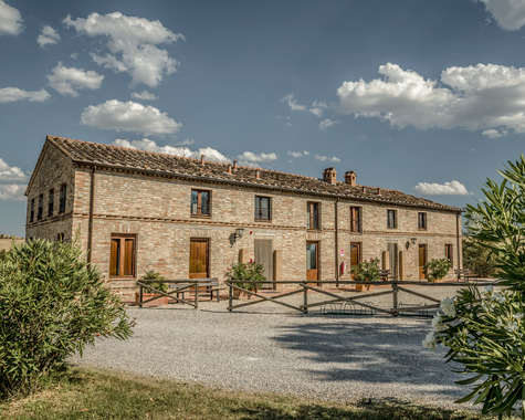 Restauriertes Landhaus mit Innenhof, umgeben von Natur und mediterranen Pflanzen.